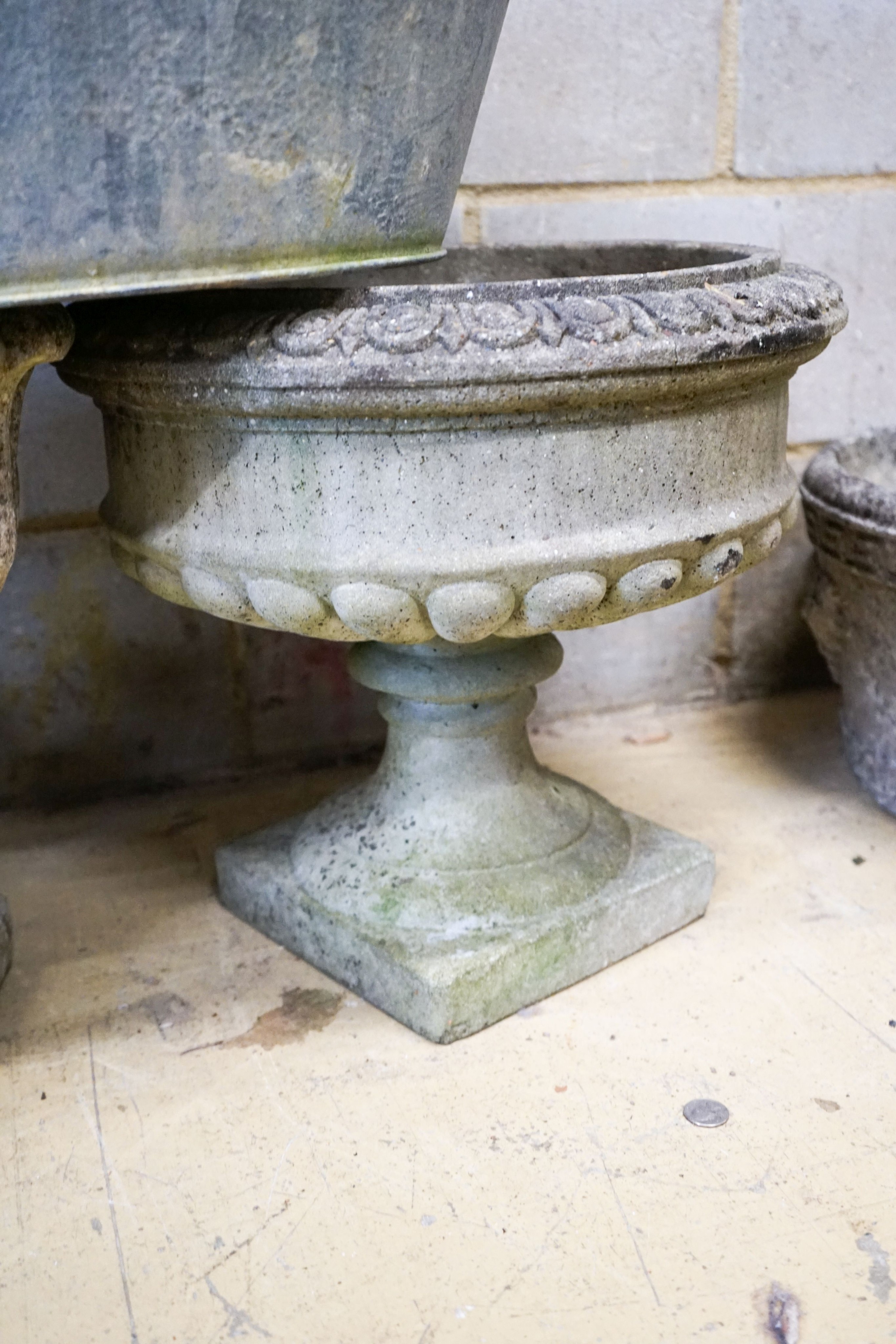 Four assorted reconstituted stone garden urns and a galvanised tub